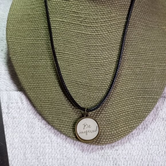 Vintage Jewelry - Goldtone be inspired round pendant on black cord necklace